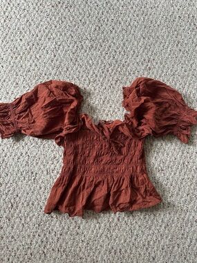 Anthropologie Rust Red Puff-Sleeve Smocked Peplum Top